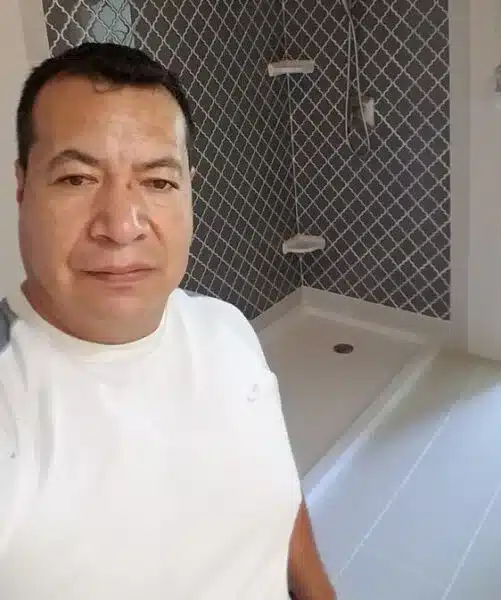 Professional contractor standing by remodeled shower about us Dallas Property Remodelers