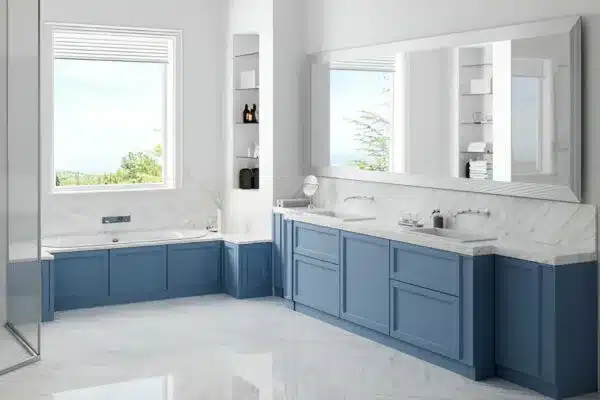 Modern bathroom with blue cabinets and marble tub by window remodeling services Dallas